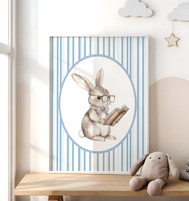 May include: A watercolor illustration of a brown bunny wearing glasses and a bow tie, holding a book. The bunny is in a white circle on a blue and white striped background.
