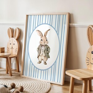May include: A watercolor illustration of a rabbit wearing a suit and bow tie. The rabbit is in a circle on a blue and white striped background.