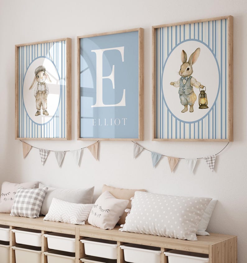 Set of 3 vintage rabbit nursery art for a boy. They feature dusty blue striped backgrounds and 2 rabbit illustrations. The third image is a dusty blue monogram and name art.