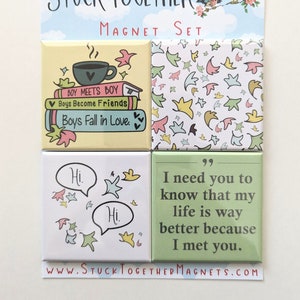 May include: Set of four square magnets with a light blue background and white stars. The magnets feature illustrations of a coffee cup, books, speech bubbles, and a quote. The text on the magnets reads "Boy Meets Boy", "Boys Become Friends", "Boys Fall in Love", "Hi", "Hi", "I need you to know that my life is way better because I met you."