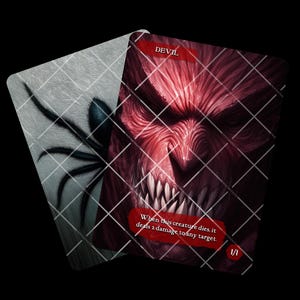 May include: Two fantasy trading cards. One card features a red devil face with sharp teeth and the word "DEVIL" in a red banner. The other card shows a black spider. Text on the devil card reads "When this creature dies, it deals 1 damage to any target."