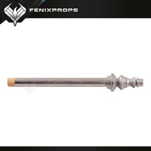 May include: A silver-colored curtain rod with a decorative end. The rod has a light tan-colored tip on one end. The other end features a detailed, ornate design. The text "FENIXPROPS" is visible in the top right corner.