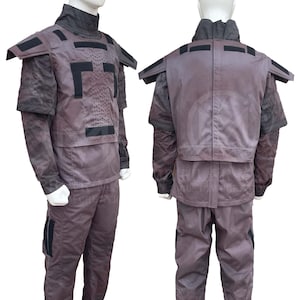 May include: A gray and black tactical vest with a camouflage pattern. The vest has a high collar and a zipper closure. The vest has a variety of pockets and straps.