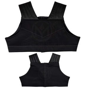 May include: Two black padded vests with adjustable straps. The vests have a simple design with a V-shaped seam in the front.