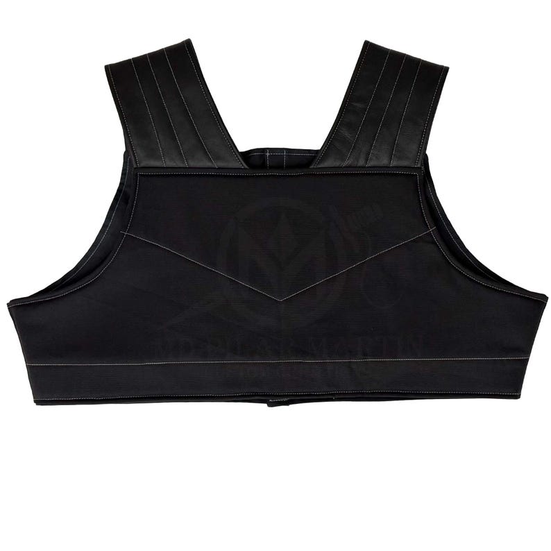 May include: Black padded vest with a wide, scoop neck and adjustable straps. The vest has a smooth, quilted texture and a simple design.