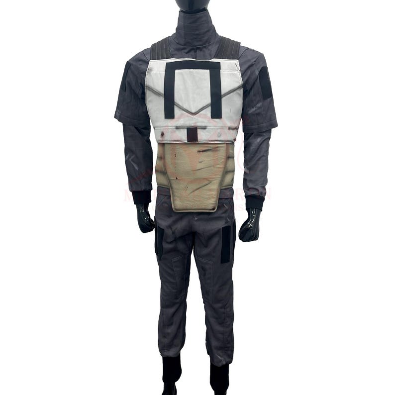 May include: A gray and white costume with a chest plate, a tan midsection, and matching pants. The costume has black gloves and boots. The chest plate has a rectangular design. The costume appears to be a replica of a movie or video game character.