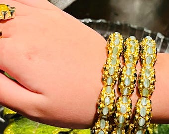 Lotus Bracelet: 24kt gold plated scalloped design with semi precious stones.