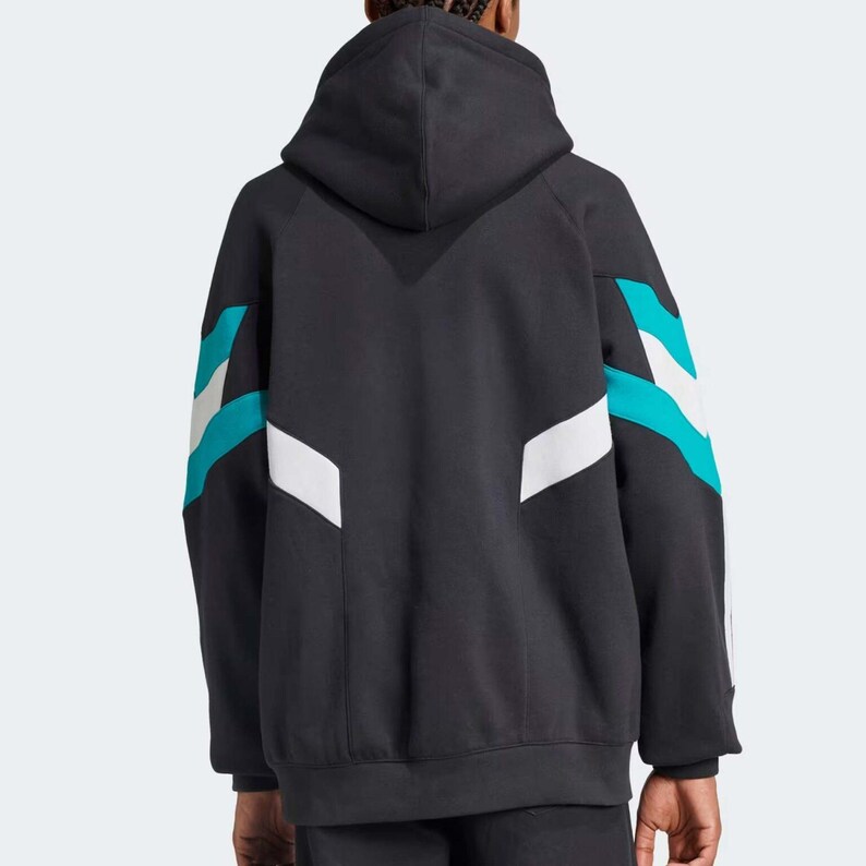 May include: Black hooded sweatshirt with teal and white geometric accents on the sleeves. The back view of the sweatshirt shows a V-shaped design at the top. The sweatshirt has a drawstring hood and ribbed cuffs and hem.