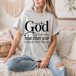 God is Still Writing Your Story Tee - Boho Christian Sweatshirt , Inspirational Bible Verse Shirt, Faith-Based Church Sweater