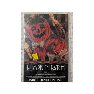 May include: A craft pattern packet titled PUMPKIN PATCH by Indygo Junction, Inc. The cover features three orange felt pumpkins with black facial features, dried corn, and straw. Text indicates patterns for 9 inch, 13 inch, and 15 inch wall hangings.