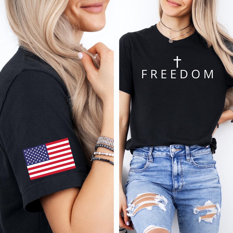 May include: Black t-shirts. One has the word "FREEDOM" with a cross above it. The other has an American flag patch on the sleeve. Both shirts are short-sleeved.