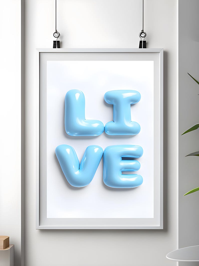 May include: A framed print with the word "LIVE" spelled out in light blue, balloon-like letters.