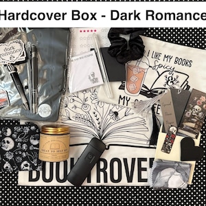 May include: A curated gift box labeled "Hardcover Box - Dark Romance" with various items. Includes pens, a scrunchie, a candle, a pouch with skulls, bookmarks, a tote bag with text, and a black flashlight.