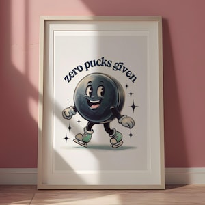 May include: A white framed print with a cartoon hockey puck wearing skates and the text "zero pucks given".