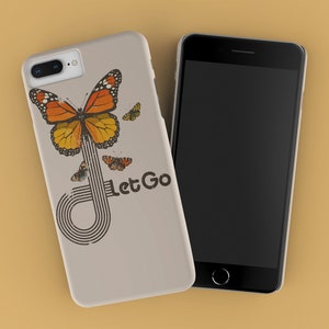May include: A beige phone case with a butterfly design and the text "Let Go". The butterfly is orange and black with a white background. The case is for an iPhone.