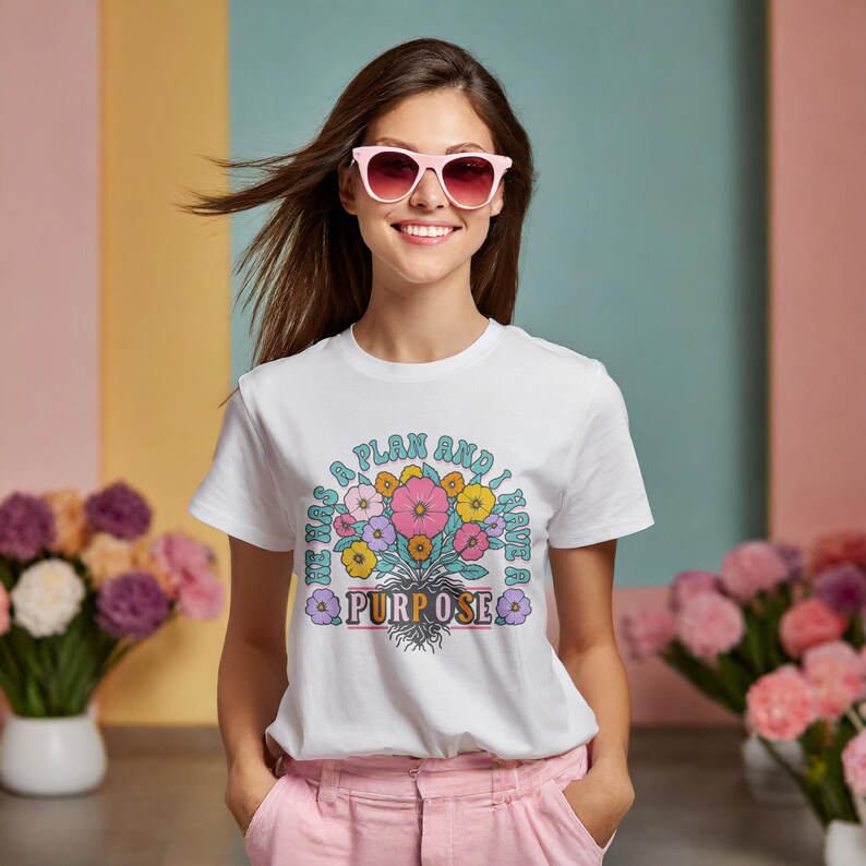 May include: White t-shirt with a floral design and the text "I have a plan and I have a purpose".