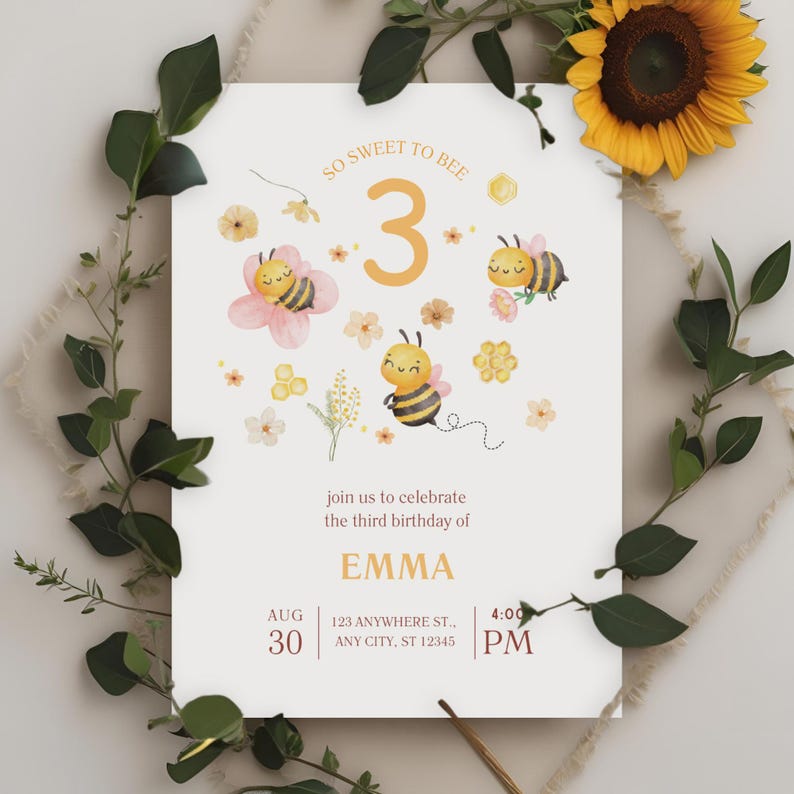 May include: A cream-colored birthday invitation with bee and flower illustrations. The text reads "So Sweet to Bee" and "join us to celebrate the third birthday of EMMA" with date, time, and address details. The invitation is surrounded by greenery and a sunflower.