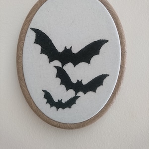 Bats silhouette. embroidery wall art. Home decor black thread on calico. Gothic Victorian. Curiosity. Framed in wood effect hoop. Spooky.