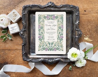 May include: A rectangular wedding invitation card featuring a decorative border of green leaves and purple thistle flowers. The text reads: You are cordially invited to the wedding of Caralene Hughes and Scott Davies, Saturday, the third of October, Two thousand twenty-six, Five o'clock, Turin Castle, Forfar, Scotland, Merriment to follow.
