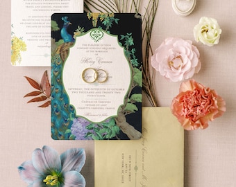 May include: A black and green wedding invitation with a peacock design. The invitation features gold rings and the text "The pleasure of your company is kindly requested at the marriage of Mary Commen and Jorge Martinez. Saturday, the fifteenth of October two thousand and twenty two, four o'clock. Chateau de Varenes, Impasse du Loup, Charette Varenes, France."