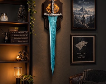 May include: A wall-mounted decorative sword featuring a textured silver hilt and a translucent, glowing blue blade with intricate leaf-like patterns. The sword is mounted on a dark wooden plaque with a circular, fiery orange emblem behind the hilt.