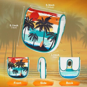May include: A golf club head cover with a tropical sunset design featuring palm trees, a surfboard, and a red sun. The cover is white with a teal trim and measures 5.3 inches (13.5cm) wide, 5.1 inches (13cm) high, and 1.1 inches (3cm) thick.