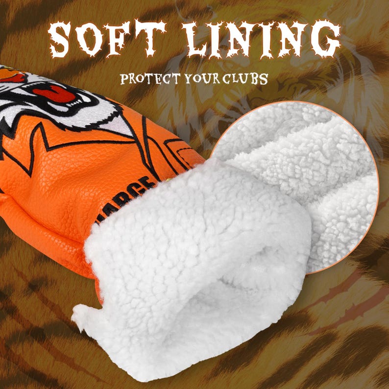 Op de afbeelding: Een oranje golfclubhoofdbeschermer met een tijgerontwerp en een witte zachte voering. De tekst "SOFT LINING" en "PROTECT YOUR CLUBS" is in het wit weergegeven.