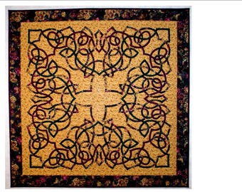 May include: A square quilt with a Celtic knot design in shades of brown, green, and burgundy. The knots are woven together in a complex pattern on a light brown background. The quilt is framed with a dark brown border with a floral pattern.