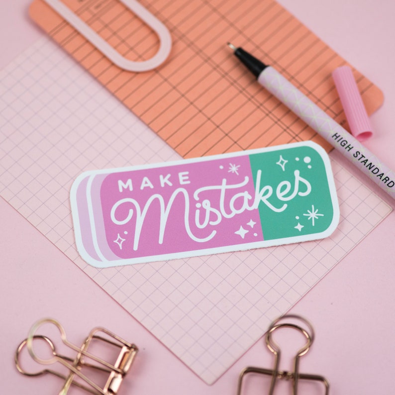 May include: Pink and green eraser sticker with the text "Make Mistakes" in white lettering. The sticker has a white border and sparkles around the text.
