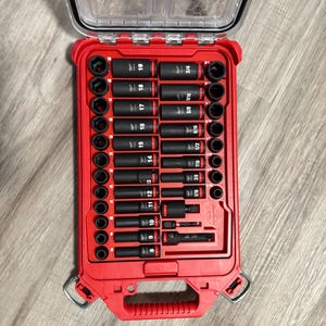 May include: A red and black tool case with a variety of socket wrenches. The case has a clear plastic lid and a handle. The sockets are labeled with their sizes, including 5/16, 3/8, 7/16, 1/2, 9/16, 5/8, 3/4, 10, 11, 12, 13, 14, 15, 16, 17, 18, and 19.