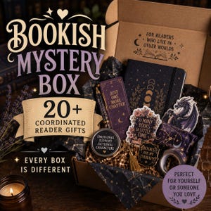 May include: A cardboard gift box containing a black journal with moon phases, a purple bookmark with the text 'JUST ONE MORE CHAPTER', a round tin labeled 'EMOTIONAL SUPPORT FICTIONAL CHARACTERS', stickers, a tassel, and a roll of patterned tape.