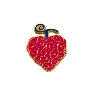May include: A red and gold heart-shaped pin with a blue swirl on top. The pin is a representation of the "Gum-Gum Fruit" from the anime series "One Piece".