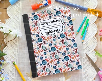 May include: Composition notebook with a colorful pattern of bows and blue circles on a white background. The notebook has a black spine and the words "Composition notebook" in a white label. Pencils, glue stick, and paint brush are in the background.