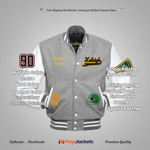 May include: A gray wool letterman jacket with white leather sleeves. The jacket features a "90" patch, the name "Kaleigh", and various school patches. The text "Add Your Name" is also visible. The jacket has a striped collar, cuffs, and hem.