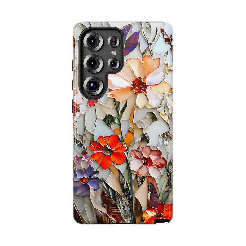 May include: A phone case with a floral design. The case features a white background with colorful flowers in shades of red, orange, yellow, and purple. The flowers are arranged in a mosaic pattern, giving the case a unique and artistic look.
