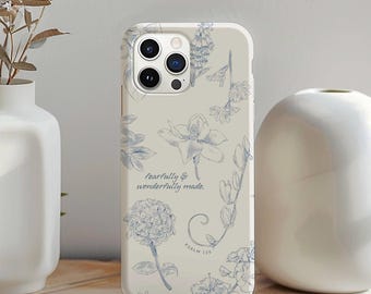 May include: A phone case with a floral design in blue and white. The case features various flower illustrations and the text "fearfully & wonderfully made. Psalm 139."