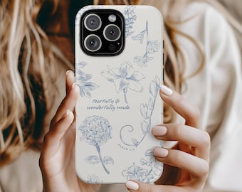 May include: A phone case with a cream background and blue floral illustrations. The case features the text "fearfully & wonderfully made" and "Psalm 139". The design includes various flower and leaf drawings.