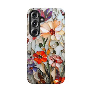 May include: A phone case with a floral design. The case features a white background with colorful flowers, including red, orange, pink, and purple. The phone case has a cutout for the camera lens.