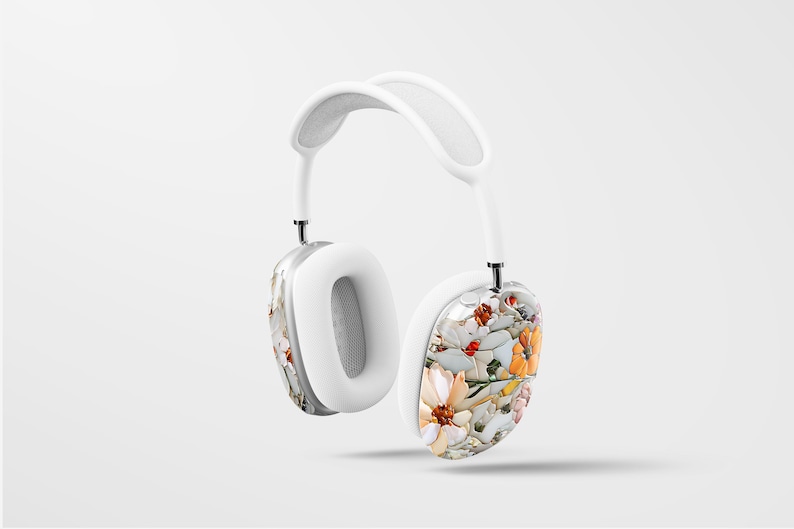 May include: White wireless headphones with a floral pattern on one earcup. The floral pattern features white, orange, and yellow flowers.