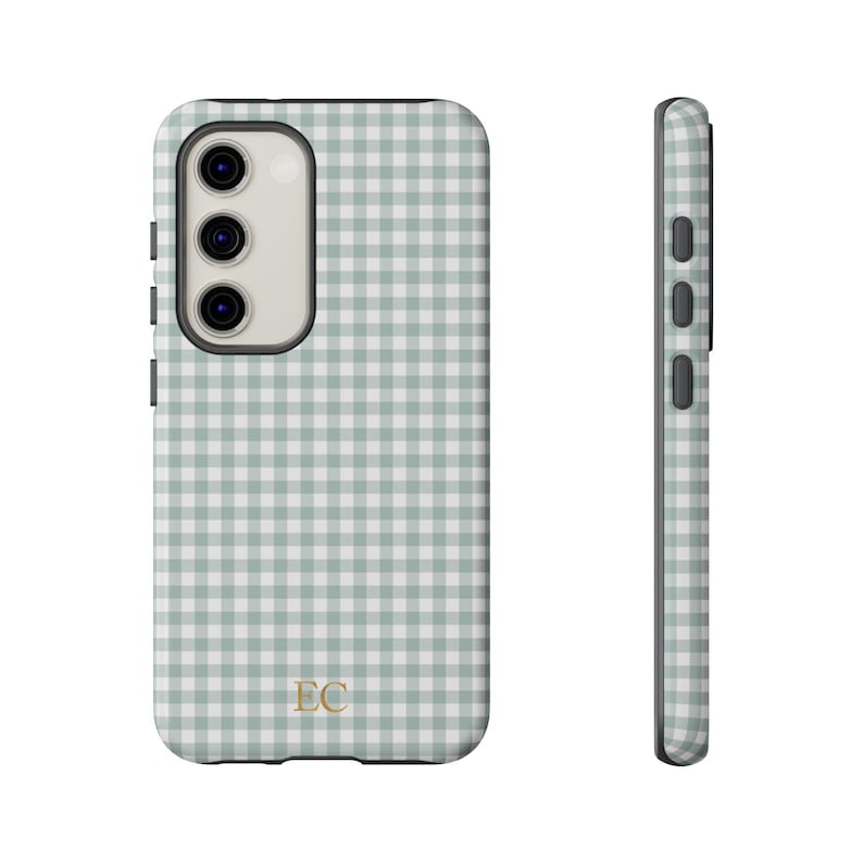 May include: A phone case with a light green and white gingham pattern. The case has a camera cutout and side buttons. The initials "EC" are in gold at the bottom. The case is shown from the front and side.