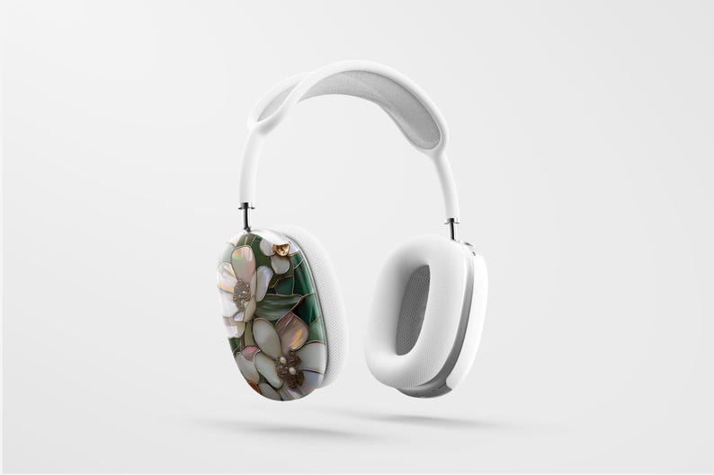May include: White over-ear headphones with a floral design on one earcup. The design features white, green, and gold accents.