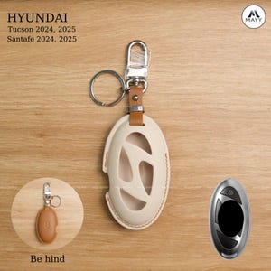 May include: Cream leather key fob cover with a cut-out design, attached to a silver keyring and clasp. Designed for Hyundai Tucson and Santa Fe models. The image also includes a remote key and the text "HYUNDAI Tucson 2024, 2025 Santafe 2024, 2025".
