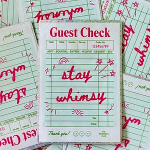 May include: A collection of whimsical guest checks with a mint green grid pattern and the words "Guest Check" and "stay whimsy" in red script. The checks have a silver glitter border and decorative doodles.