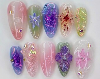 May include: Ten long, oval-shaped, clear acrylic false nails with different floral designs. The designs include a purple flower, a pink flower, a red flower, a butterfly, and a swirl pattern.