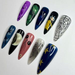 Coraline press on, Gothic nail art, Spooky press nails, Creepy cute nails, Halloween fake nails, Handmade false nails, Horror nail design, Dark aesthetic nails, Unique press on set, Witchy nail art, Long stiletto nails, Movie inspired nails, Alternative nails, Custom nail design, Holiday nails, Party nails