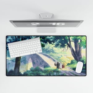 May include: A colourful mouse mat with a scenic landscape featuring a stone bridge, trees, and people walking on a path. The mouse mat has a white keyboard and a white mouse on it.