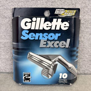 May include: A package of Gillette Sensor Excel razor cartridges. The package is primarily dark blue with the brand name and product name in white and light blue. The package includes a silver razor and the text "10 Cartridges".