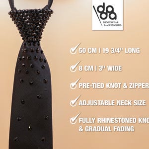 May include: A black necktie featuring a fully rhinestoned knot and a gradual fading pattern of black crystals down the fabric. The tie includes a pre-tied knot, a zipper mechanism, and an adjustable neck size. It measures 19 3/4 inches long and 3 inches wide.