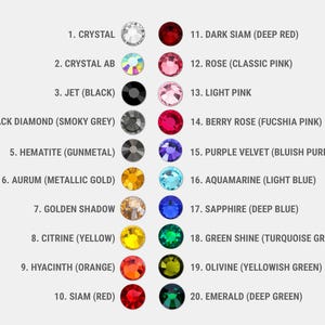 May include: A color chart featuring twenty numbered circular crystals arranged in two columns. Each entry lists a name and color description, including Crystal, Crystal AB, Jet, Black Diamond, Hematite, Aurum, Golden Shadow, Citrine, Hyacinth, Siam, Dark Siam, Rose, Light Pink, Berry Rose, Purple Velvet, Aquamarine, Sapphire, Green Shine, Olivine, and Emerald.