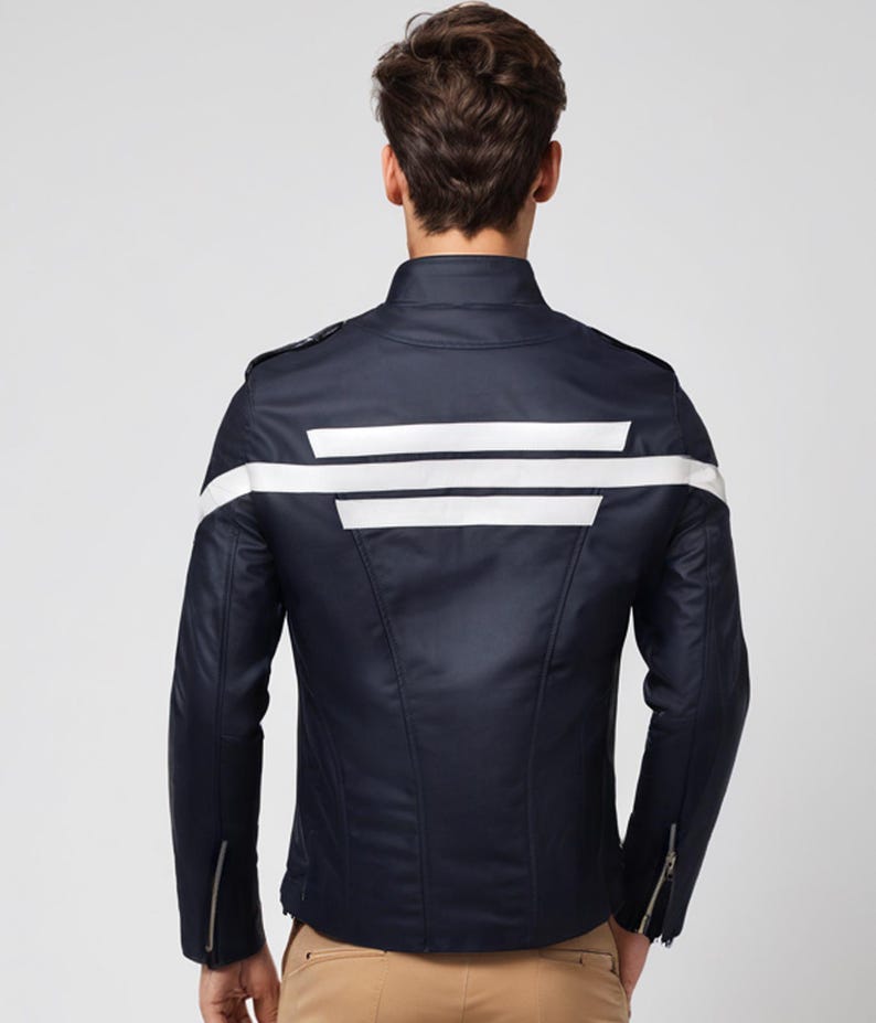 May include: Navy blue jacket with white stripes across the back and sleeves. The jacket has a stand-up collar, zipper details on the sleeves, and a tailored fit. The jacket is a stylish outerwear piece.